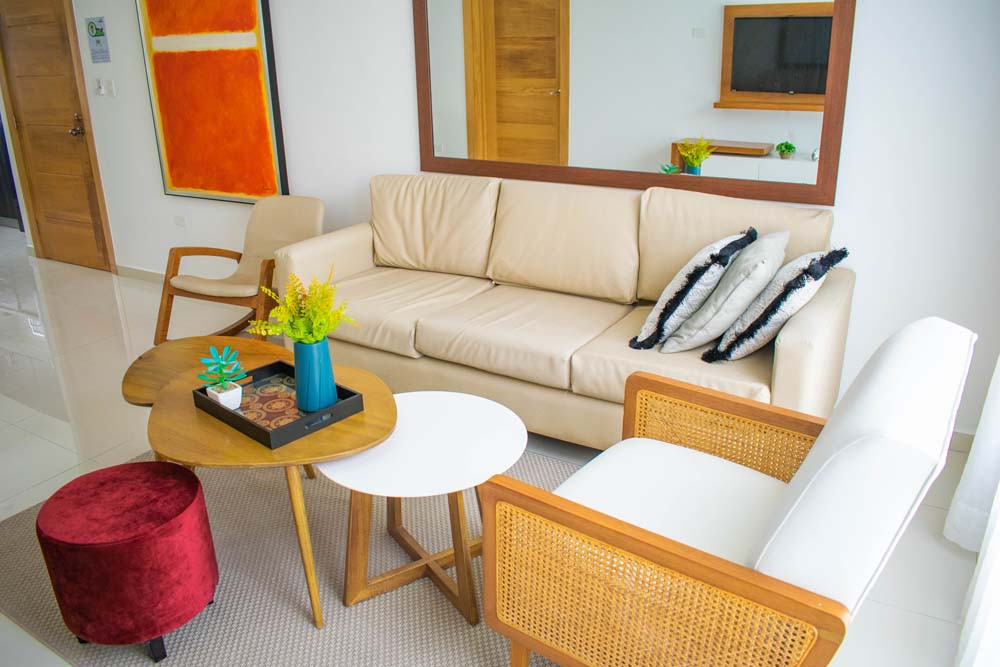 Lounge furniture and mirror in an apartment at Beach Apartamentos in Playa Palmera 